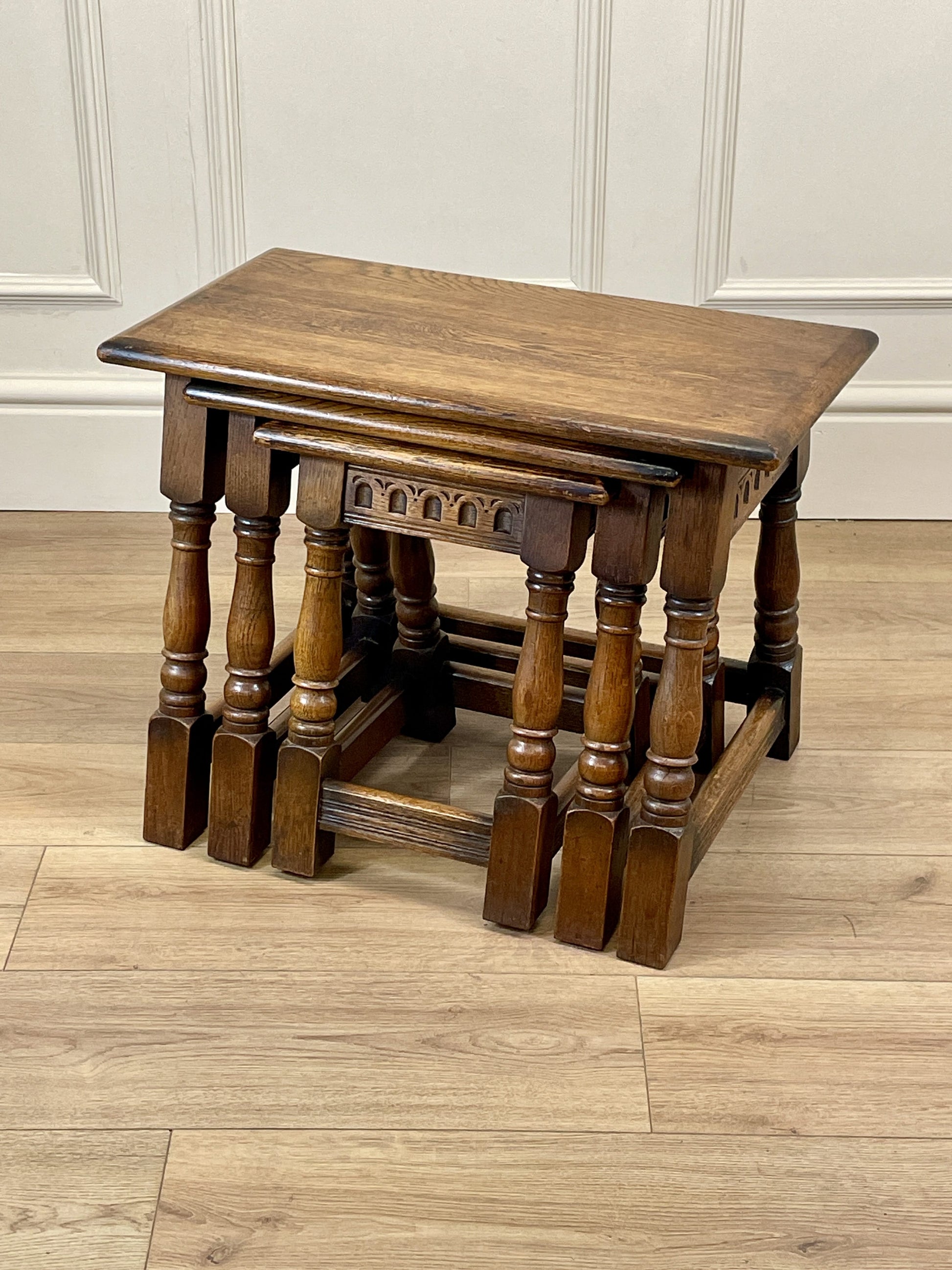Vintage solid oak nest of 3 small tables with carved detail and splayed legs. Restored and ideal as practical antique side tables in any living room.