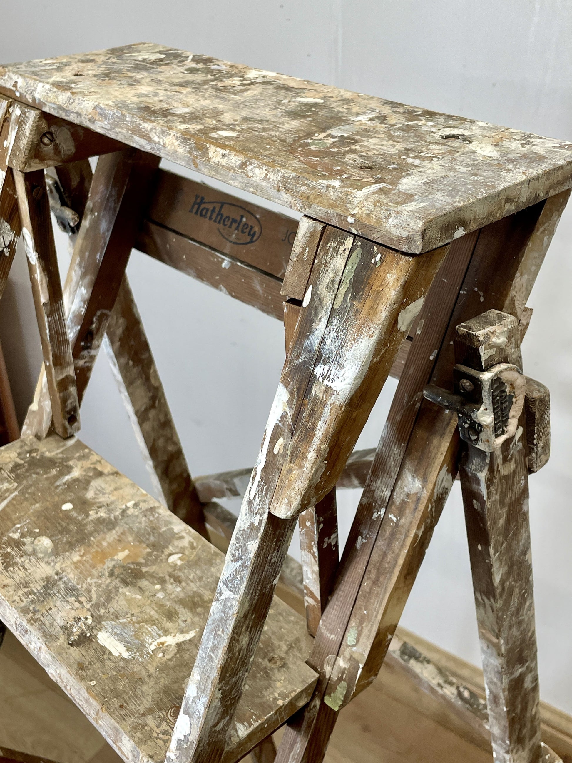 Worn wooden step ladder with 'Hathaway' branding on a plain background