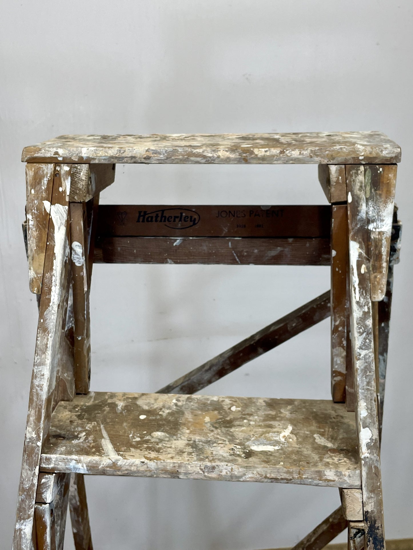 Worn wooden step ladder with 'Hatherton' branding on a plain background